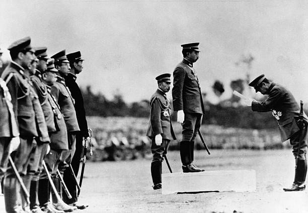 Emperor Hirohito of Japan receives a bow from the leader of a military unit during a troop review during World War II. Emperor Hirohito of Japan receives a bow from the leader of a military unit during a troop review during World War II.